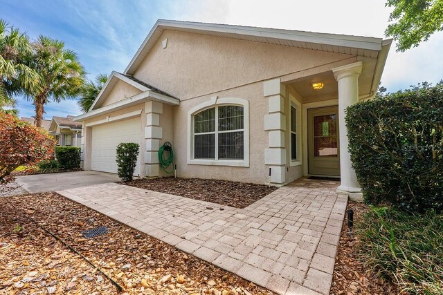 39900 Bayview Dr, Lady Lake, FL 32159 - view of front of property with concrete driveway, stucco siding, and an attached garage