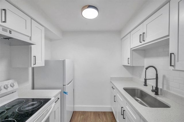 kitchen featuring white range with electric cooktop, tasteful backsplash, white cabinetry, under cabinet range hood, and a sink