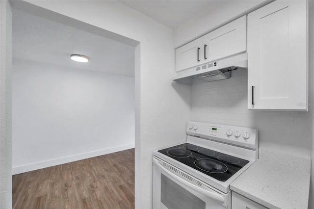 kitchen with baseboards, white cabinets, under cabinet range hood, white electric range oven, and wood finished floors