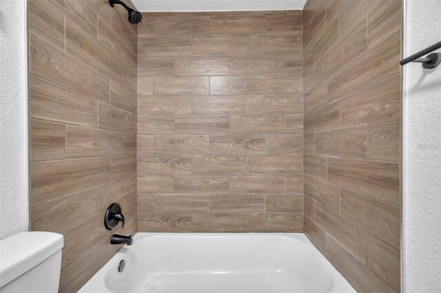 bathroom featuring toilet and tub / shower combination