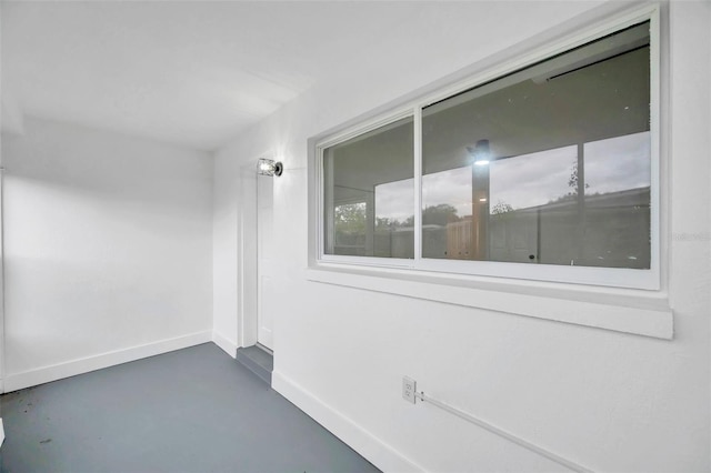 exterior space featuring concrete floors and baseboards