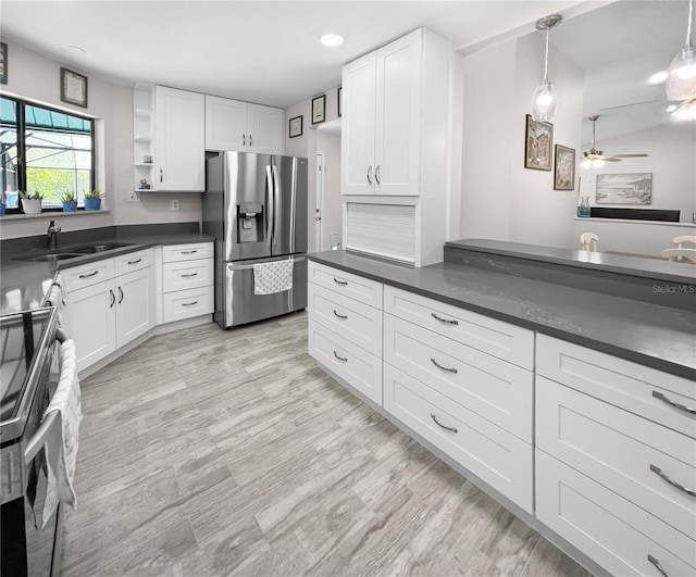 11404 Lokanotosa Trl, Orlando, FL 32817 - kitchen featuring white cabinets, stainless steel appliances, and dark countertops