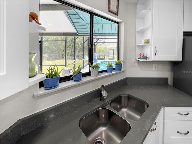 11404 Lokanotosa Trl, Orlando, FL 32817 - kitchen featuring white cabinetry, a sink, open shelves, and a wealth of natural light