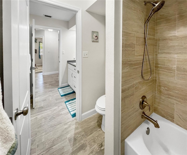 11404 Lokanotosa Trl, Orlando, FL 32817 - bathroom with toilet, vanity, baseboards, and bathing tub / shower combination