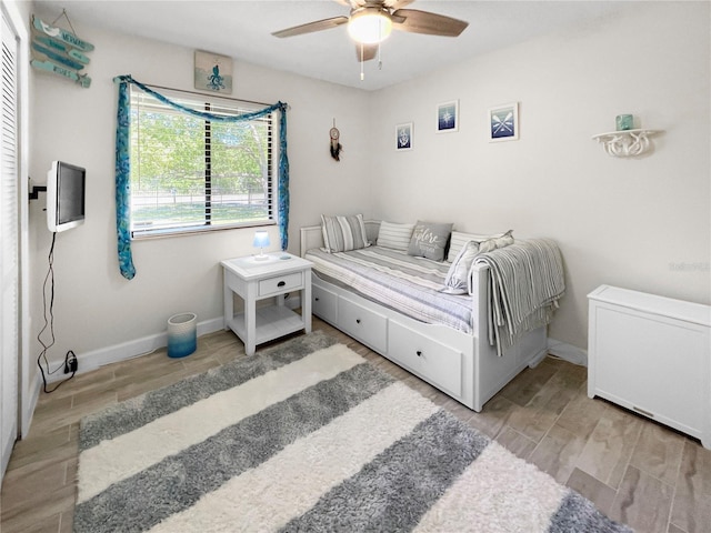 11404 Lokanotosa Trl, Orlando, FL 32817 - bedroom featuring baseboards, ceiling fan, and wood tiled floor