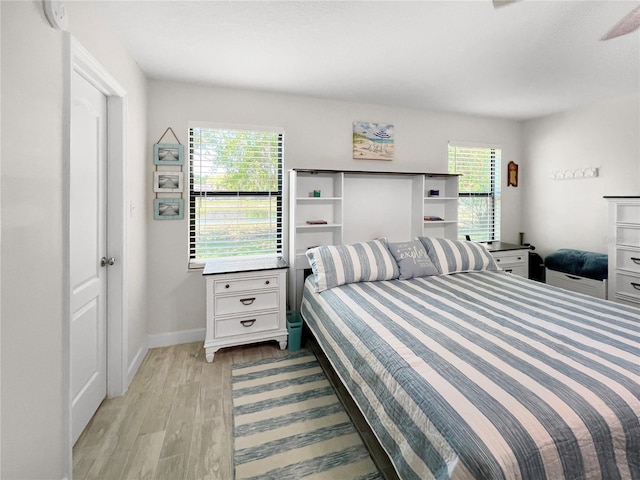 11404 Lokanotosa Trl, Orlando, FL 32817 - bedroom with light wood-style floors, baseboards, and multiple windows