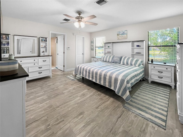 11404 Lokanotosa Trl, Orlando, FL 32817 - bedroom featuring baseboards, ceiling fan, visible vents, and light wood finished floors