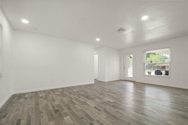 4385 Cassius St, Orlando, FL 32811 - empty room featuring wood finished floors, recessed lighting, and baseboards