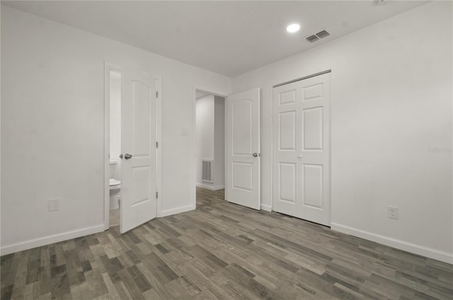 4385 Cassius St, Orlando, FL 32811 - unfurnished bedroom with wood finished floors, baseboards, recessed lighting, ensuite bath, and a closet