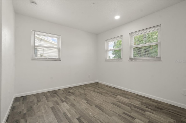 4385 Cassius St, Orlando, FL 32811 - spare room featuring wood finished floors, baseboards, a smoke detector, and recessed lighting