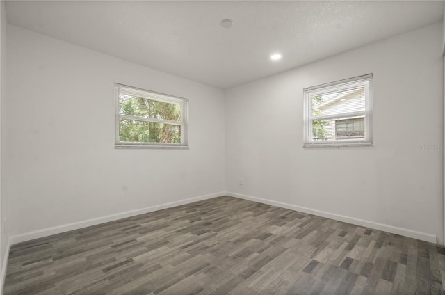 4385 Cassius St, Orlando, FL 32811 - spare room with healthy amount of natural light, wood finished floors, baseboards, and recessed lighting