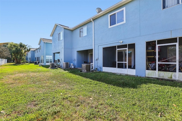 534 Wilton Cir, Sanford, FL 32773 - rear view of property featuring cooling unit, stucco siding, and a lawn