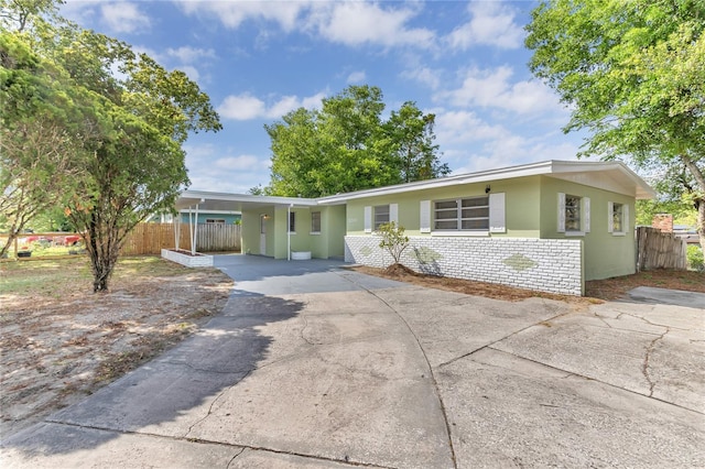 5201 Van Aken Dr, Orlando, FL 32808 - view of front of home with fence, concrete driveway, and a carport