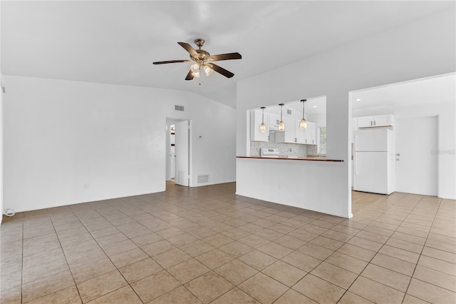 5201 Van Aken Dr, Orlando, FL 32808 - unfurnished living room with a ceiling fan, light tile patterned flooring, lofted ceiling, and visible vents