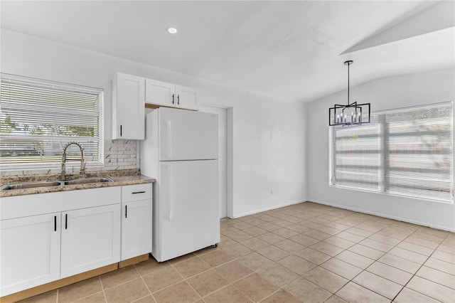 5201 Van Aken Dr, Orlando, FL 32808 - kitchen featuring white cabinetry, a sink, backsplash, a notable chandelier, and freestanding refrigerator