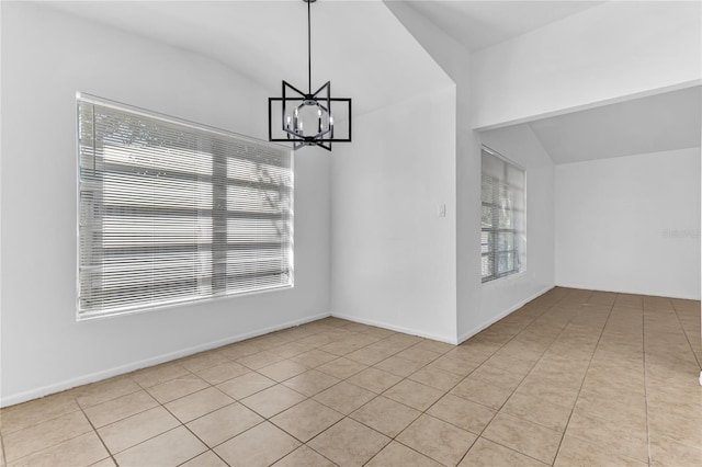 5201 Van Aken Dr, Orlando, FL 32808 - unfurnished dining area with vaulted ceiling, light tile patterned floors, and an inviting chandelier