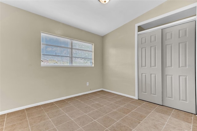 5201 Van Aken Dr, Orlando, FL 32808 - unfurnished bedroom with light tile patterned flooring, baseboards, and a closet