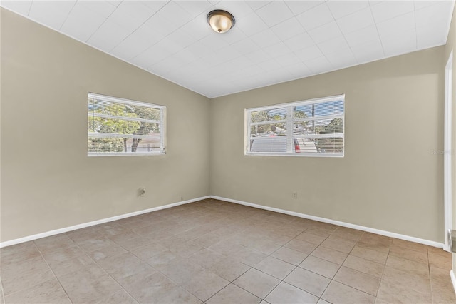 5201 Van Aken Dr, Orlando, FL 32808 - unfurnished room with baseboards, vaulted ceiling, and light tile patterned floors