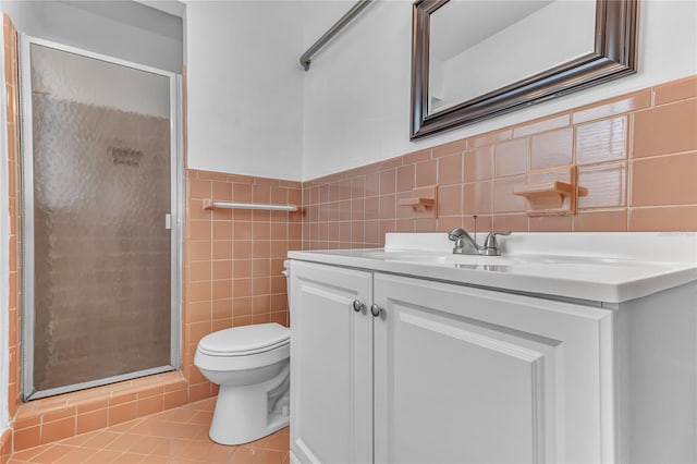 5201 Van Aken Dr, Orlando, FL 32808 - full bath featuring tile patterned floors, toilet, vanity, a shower stall, and tile walls