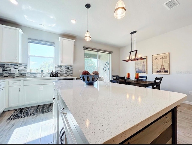 11826 Sky Acres Ter, Bradenton, FL 34211 - kitchen featuring plenty of natural light, backsplash, white cabinetry, and recessed lighting