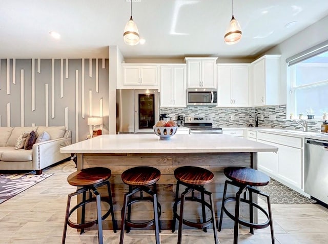11826 Sky Acres Ter, Bradenton, FL 34211 - kitchen with appliances with stainless steel finishes, tasteful backsplash, white cabinetry, and light countertops
