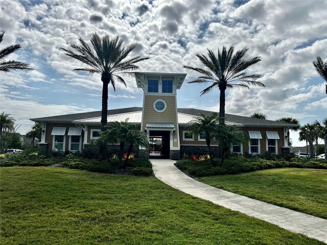 11826 Sky Acres Ter, Bradenton, FL 34211 - view of front facade featuring a standing seam roof, a front lawn, a metal roof, and stone siding