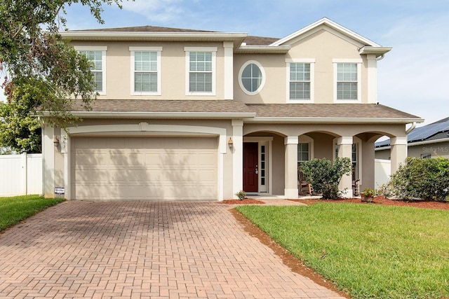563 Copperdale Ave, Winter Garden, FL 34787 - view of front facade with decorative driveway, stucco siding, and fence