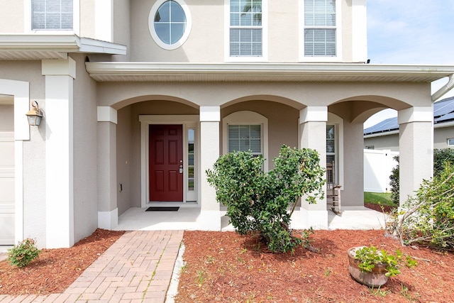 563 Copperdale Ave, Winter Garden, FL 34787 - doorway to property featuring a garage and stucco siding