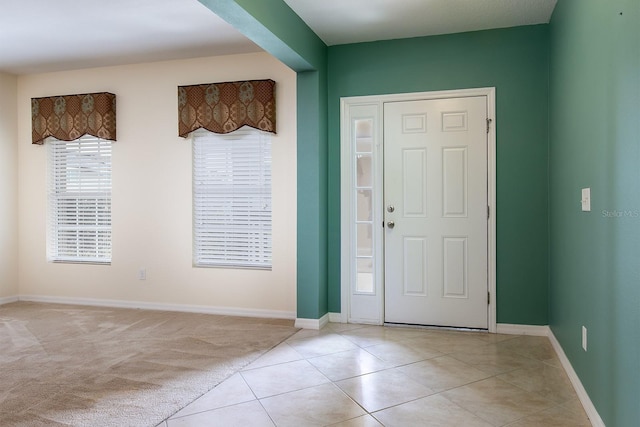 563 Copperdale Ave, Winter Garden, FL 34787 - entryway featuring light tile patterned floors, baseboards, and light colored carpet