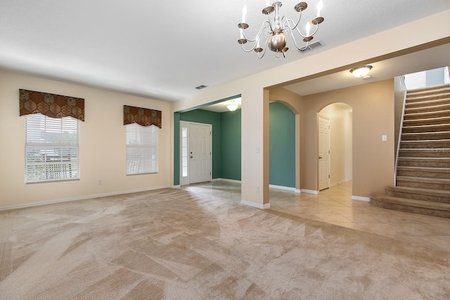 563 Copperdale Ave, Winter Garden, FL 34787 - unfurnished living room with stairs, a chandelier, arched walkways, visible vents, and light carpet