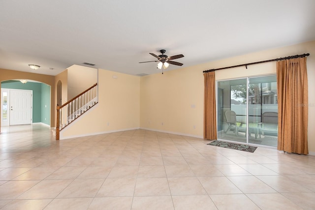 563 Copperdale Ave, Winter Garden, FL 34787 - spare room with light tile patterned flooring, visible vents, stairs, a ceiling fan, and arched walkways