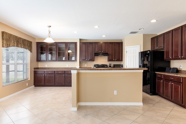 563 Copperdale Ave, Winter Garden, FL 34787 - kitchen with dark brown cabinets, a kitchen island, glass insert cabinets, under cabinet range hood, and black appliances