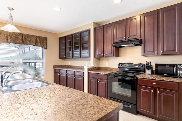 563 Copperdale Ave, Winter Garden, FL 34787 - kitchen with under cabinet range hood, glass insert cabinets, a sink, pendant lighting, and black appliances