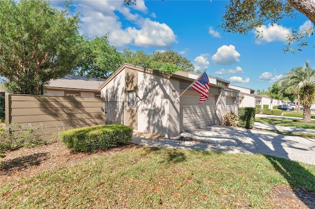218 Nettlewood Ln, Fern Park, FL 32730 - view of property exterior with concrete driveway, a garage, and fence