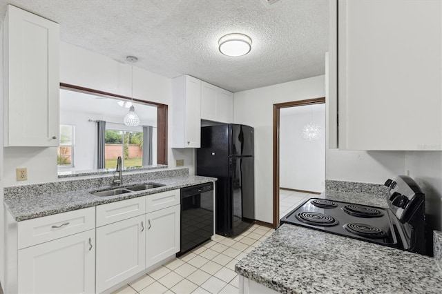 7602 Glenmoor Ln, Winter Park, FL 32792 - kitchen featuring a sink, white cabinets, light stone countertops, hanging light fixtures, and black appliances
