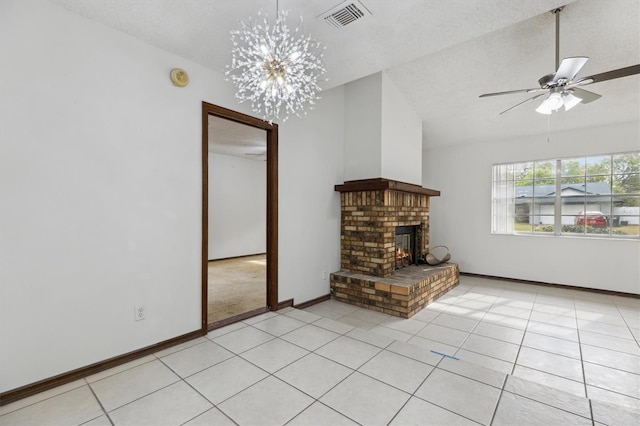 7602 Glenmoor Ln, Winter Park, FL 32792 - unfurnished living room with a textured ceiling, visible vents, a fireplace, vaulted ceiling, and light tile patterned floors