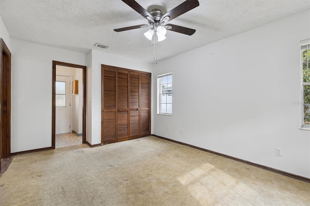 7602 Glenmoor Ln, Winter Park, FL 32792 - unfurnished bedroom featuring carpet, a closet, a textured ceiling, and visible vents