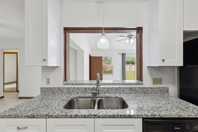 7602 Glenmoor Ln, Winter Park, FL 32792 - kitchen with white cabinetry, a sink, dishwashing machine, and light stone countertops