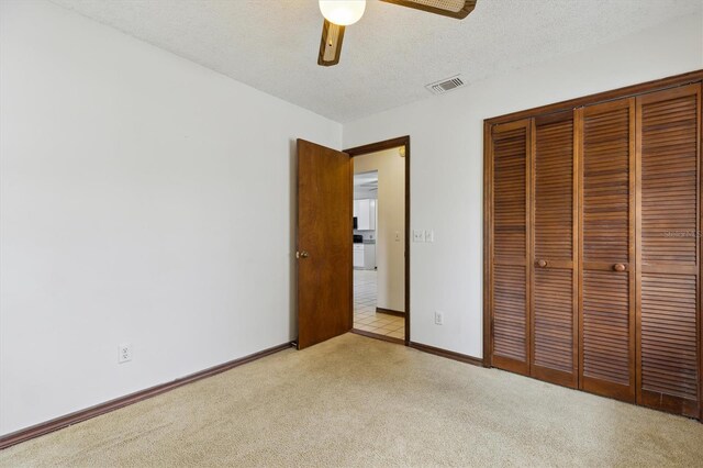 7602 Glenmoor Ln, Winter Park, FL 32792 - unfurnished bedroom with a closet, a textured ceiling, baseboards, light colored carpet, and visible vents