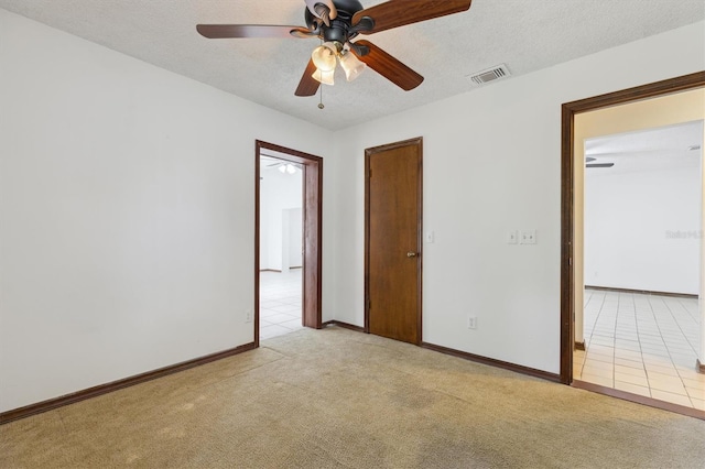 7602 Glenmoor Ln, Winter Park, FL 32792 - unfurnished bedroom featuring tile patterned floors, carpet flooring, a textured ceiling, baseboards, and visible vents