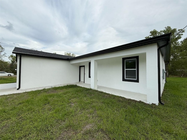 54 Malauka Trak, Ocklawaha, FL 32179 - back of property featuring a yard and stucco siding