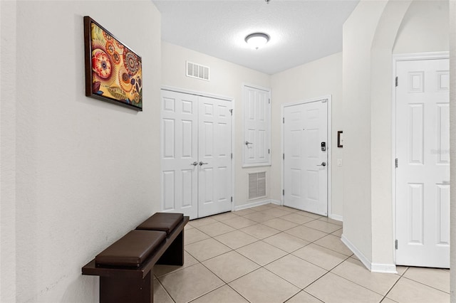 4114 Breakview Dr Unit 11002, Orlando, FL 32819 - foyer with light tile patterned flooring, arched walkways, baseboards, and visible vents