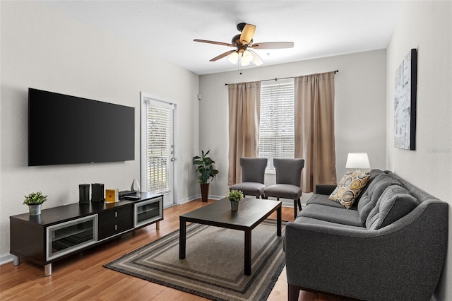 4114 Breakview Dr Unit 11002, Orlando, FL 32819 - living room featuring a ceiling fan, baseboards, and light wood finished floors