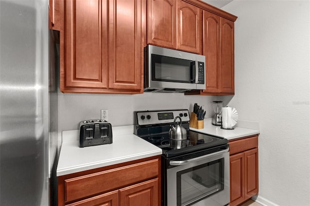 4114 Breakview Dr Unit 11002, Orlando, FL 32819 - kitchen with light countertops, appliances with stainless steel finishes, and brown cabinets