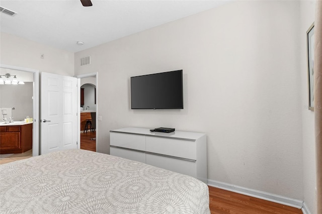 4114 Breakview Dr Unit 11002, Orlando, FL 32819 - bedroom with light wood-type flooring, arched walkways, baseboards, and visible vents