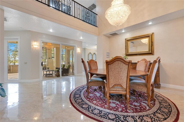 2910 Frontier Dr, Kissimmee, FL 34744 - dining area featuring baseboards, marble finish floor, visible vents, and an inviting chandelier