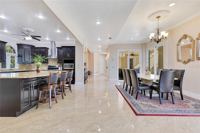 2910 Frontier Dr, Kissimmee, FL 34744 - dining room featuring marble finish floor, baseboards, ornamental molding, and ceiling fan with notable chandelier
