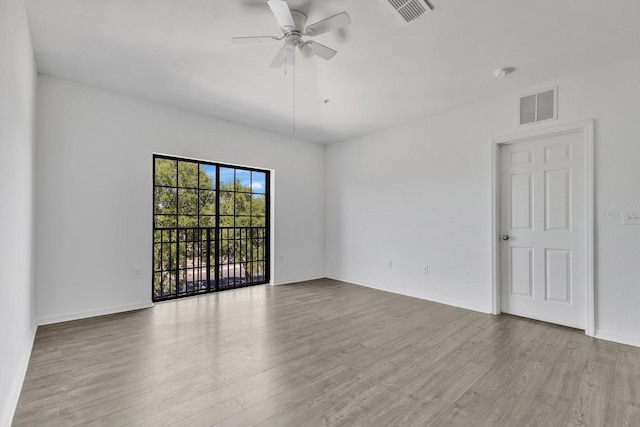 5550 E Michigan St Unit 3325, Orlando, FL 32822 - spare room with wood finished floors, baseboards, ceiling fan, and visible vents