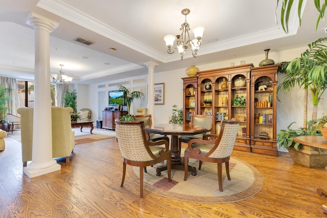 5550 E Michigan St Unit 3325, Orlando, FL 32822 - dining space with a chandelier, a raised ceiling, light wood-type flooring, visible vents, and ornate columns