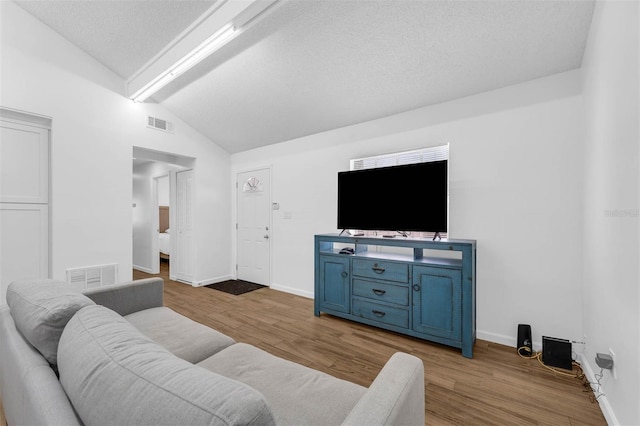 4066 Vanet Ct, Orlando, FL 32822 - living area with vaulted ceiling with beams, visible vents, and wood finished floors